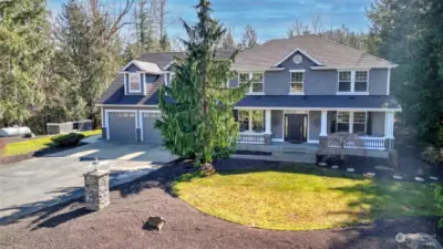 Enjoy the enchanted curb appeal of this wooded haven!