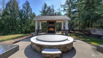 Large in-ground hot tub just off the covered patio.