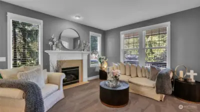 Formal dining room boasts large windows, recessed lighting, and modern fireplace.