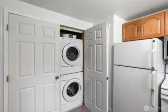 Full-size washer and dryer located in the kitchen.