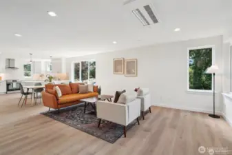Photos of staged unit, 20313A. Floor plans are identical. Expansive living room with LVP flooring and ceiling mounted high efficiency heating and cooling mini-split system