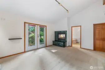 Primary bedroom with french doors leading to the waterfront side of the home.