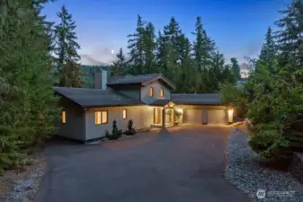The home fits naturally into the landscape and features lake a territorial views.