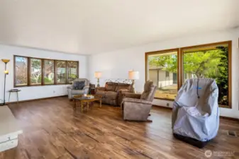 The living room is spacious enough to put a large sectional, area rug, and large TV as you cozy up to the log fire and invite guests to hang out with you.