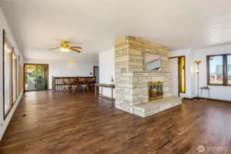 Here is the lakeview sitting area on the left and the living room to the right, facing the front yard, this would be so cozy with rustic furniture! The lake view sitting area has a lot of possibilities!
