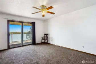 The primary bedroom has sliding glass doors out to the spacious deck, and what a view of the lake! With a ceiling fan, brand new carpeting, and a little imagination, this will be one of your most comfortable places in your new home.