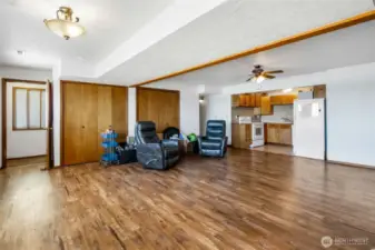Another view of the lower floor living room shows the staircase door to the left.  Close and lock it and have your own space. There are two sets of closets here, and it's nice and cool down here, even in the summer, while you're whipping up a fruit salad in the full kitchen, all appliances included in here as well.