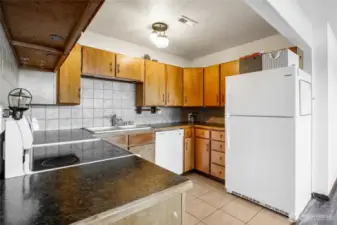 The second kitchen is here in the basement with all the necessary appliances and cupboard space, including the refrigerator, stove/range, and dishwasher.  The ceramic tile flooring makes for easy cleanup!