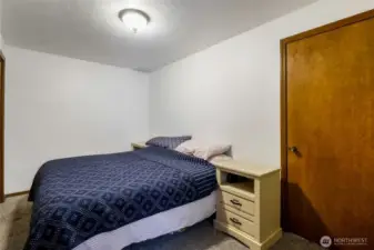 This is bedroom #4, also on the lower level, and comfortably fits a queen size bed in it.  The closet is across from the foot of the bed, and the door gives you access to bedroom #3.