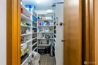 The large storage pantry is on the lower level, perfectly placed between the lower level garage and second kitchen.