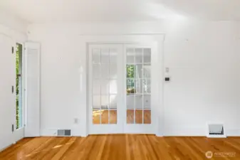 Glass, French doors, separate the living area...