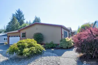 Double car attached garage, nice sidewalks, lovely shrubbery, low maintenance front yard.