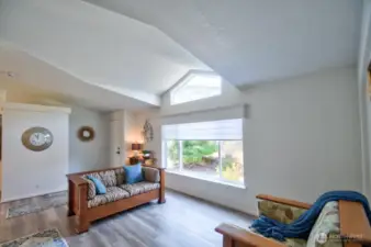 Entry to living room with grand picture window and transom window for lots of natural light.