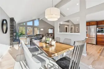 The Living room adjoins the Dining room and kitchen to form a great room w under vaulted beam ceilings and architecturally interesting framing opening views to all areas.
