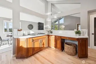 "L" shaped separation island had serving counters for serving. Quartz countertops and backsplash provide plenty of work and serving space.