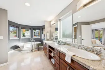Primary bath has heated tile floors recessed and vanity lighting...