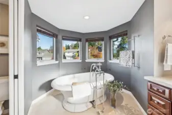 free standing tub within a surround wall of windows, water closet...