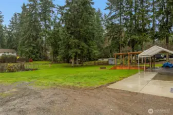 The backyard backs to the neighbor's backyard making a nice open feeling. The property line is on just this side of the garden and disk golf target. This is a nice roomy 1/2 acre lot.