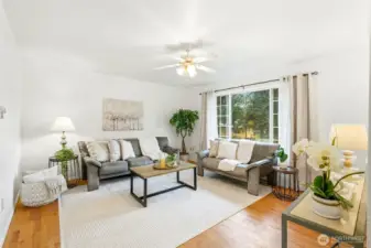Large bright and spacious living room right off of the kitchen .