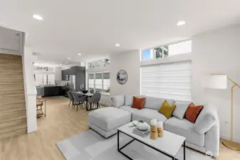 A sunlit great room framed by wide plank floors and clean finishes offers modern elegance.