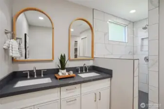 Primary bathroom with new tile shower, private toilet room, and walk in closet