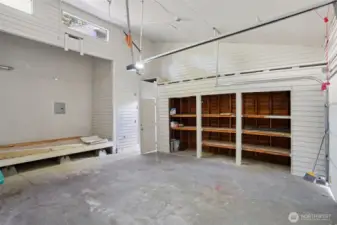 Barely detached 2 Car Garage with extra shelved storage, workshop space, and upper windows!