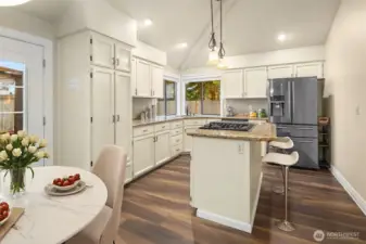 Vaulted ceilings in kitchen, eating area, and family room with southern exposure providing much needed natural light throughout the year (Digitally staged).