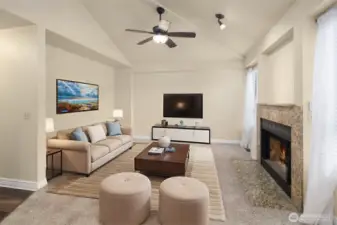Love this family room with vaulted ceilings, ceiling fan, cozy fireplace, and windows with peaceful views of the backyard. (Digitally staged).