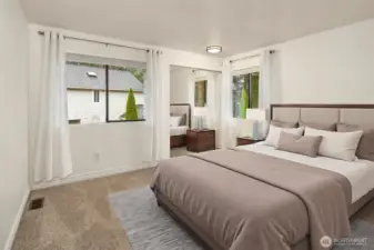 One of the three upstairs bedrooms (in addition to the bedroom on the main floor) with spacious closet and new lighting. (Digitally staged).