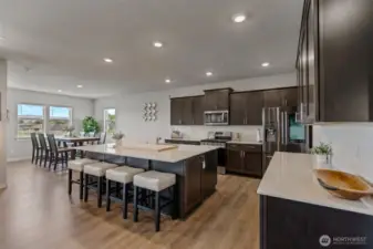 Large open kitchen with huge island and great for entertaining. There's a walk-in pantry, stainless appliances and quartz counters.