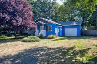 Surrounded by greenery, this charming home boasts - a new roof (2021), New paint (2021-22), New water heater (2018-19), Newer fenced backyard, Surveyed, RV Hookup +more!