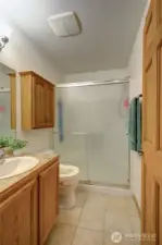 Three-quarter bathroom with easy, step-in shower and ceramic tile floors for easy care.