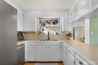 Kitchen window overlooks sunroom and back yard