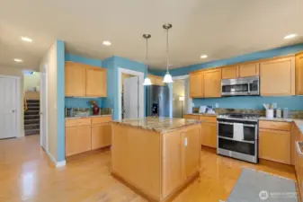Open kitchen/ casual dining + den w/ fireplace