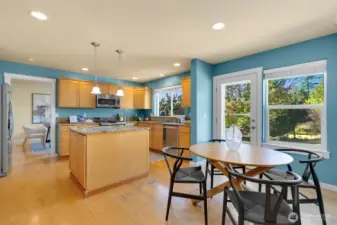 Open kitchen/ casual dining + den w/ fireplace