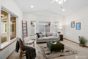 Living room with large windows bringing in ample natural light.