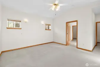 Large spacious primary with ceiling fan and natural light.