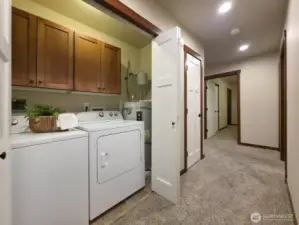 In-unit laundry closet, hallway leads to bedrooms & bathrooms.
