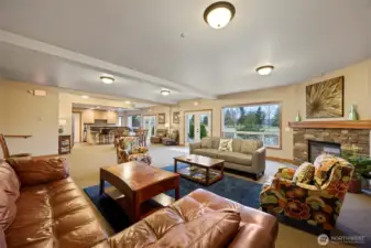 The spacious community space has comfortable couches for lounging, a gas fireplace, kitchen, 1/2 bath and community patio space.