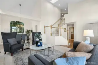 Angle looking towards the formal dining room. Note the light flooding skylight at the top of the stairs.