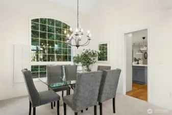 Formal dining room with a beautiful backyard outlook.