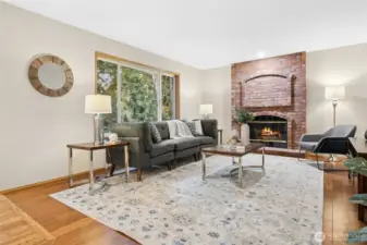 Family room with a wall of windows allowing for lots of natural light.