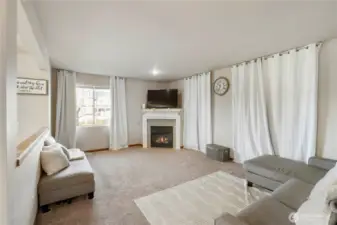 Warm space for entertaining and cosy up in front of the fire on the cool evenings. Behind the curtain on the right side you will find a sliding glass door opens up to a small patio space.