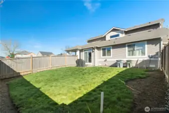 Fenced yard. Great area for a barbeque or a game of volleyball. Glass door entry to the kitchen and a side gate provides access to the driveway.