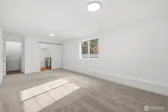 Large lower-level space perfect for a media room, playroom, or additional living area, with nearby laundry and a half bath for added convenience.