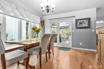 Dining room features hard wood floors with access to the partially covered wrap-around deck. Kitchen is right around the corner to your right.