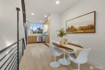 Dining room space! High ceilings distort the photo; In person this is great volume.
