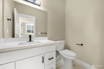 The downstairs guest bathroom.  The laundry room can be seen through the mirror.