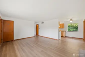 Front entry, living room, dining space and access to hallway and kitchen.