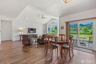Dining area with not just one, but two sliders to the massive, fully covered back deck. High ceilings live large!